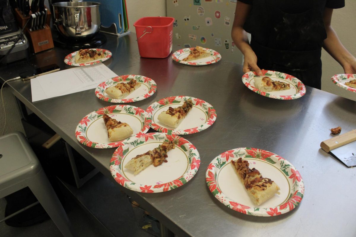 BHS culinary students plate their pizzas before they are delivered to judges on Dec. 14. 