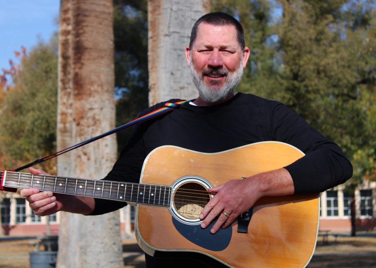 Paul Ogilvie is seen in Elm Grove with his guitar.