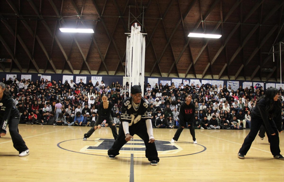 Venom dance team taking center court during the Winter sports Rally.