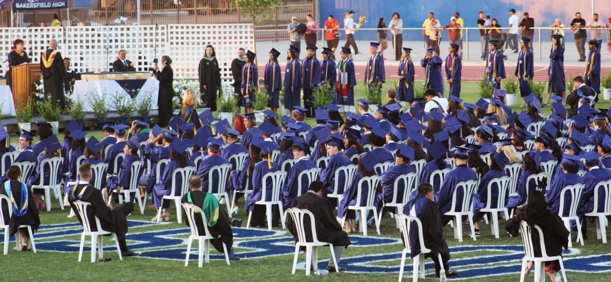 The graduates watch as students begin to receive their diplomas.