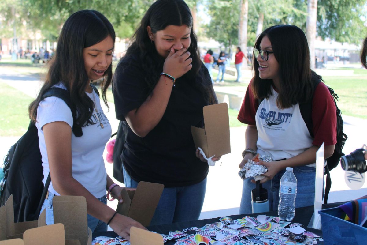 Students decorate boxes with stickers that include encouraging messages.