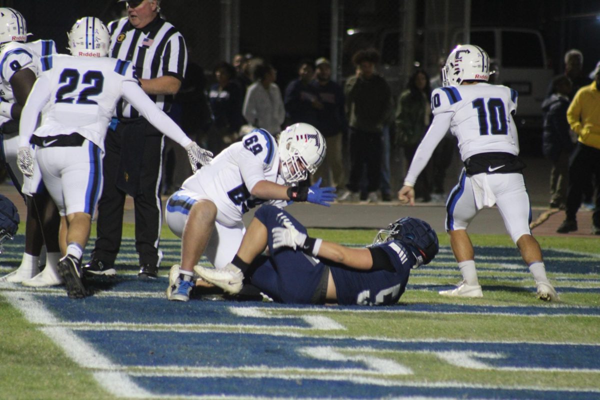 A Frontier player helps a Driller up.